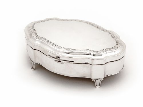 shaped silver jewellery box standing on four scroll feet with blue velvet lining - CATEGORY: ANTIQUE SILVER - DATED 1910