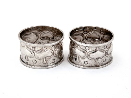 pair of arts and crafts style silver napkin rings chased with stylised foliage - CATEGORY: ANTIQUE SILVER - DATED 1900
