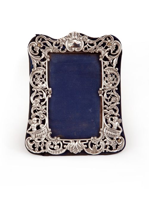 ANTIQUE SILVER WILLIAM COMYNS PHOTO FRAME DECORATED WITH FLOWERS SCROLLS AND CHERUBS - ADDITIONAL PHOTO 1