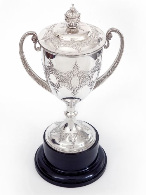 antique silver plated trophy with two cast scroll handles standing on a black plinth - CATEGORY: ANTIQUE SILVER - DATED 1890