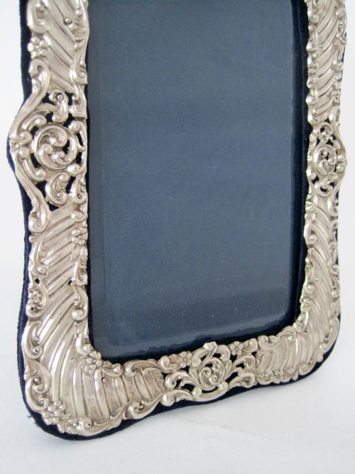 LATE VICTORIAN SILVER PHOTO FRAME DECORATED WITH SCROLLS AND FLOWERS - ADDITIONAL PHOTO 1