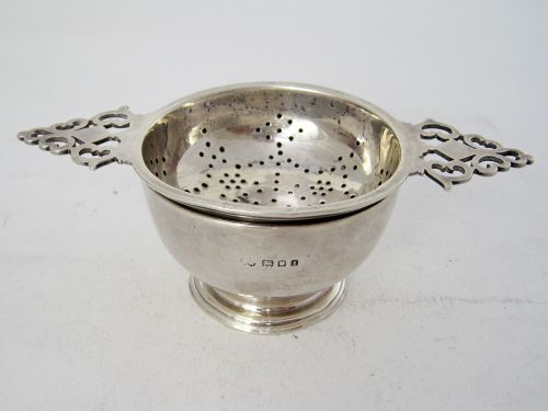 silver tea strainer and bowl with two pierced keyhole style handles - CATEGORY: ANTIQUE SILVER - DATED 1920