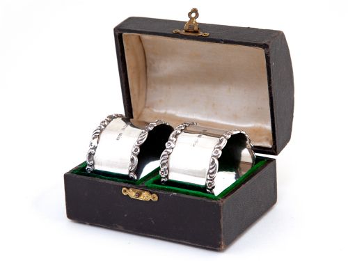 pair of boxed edwardian silver napkin rings with plain bodies and floral and scroll borders - CATEGORY: ANTIQUE SILVER - DATED EDWARDIAN