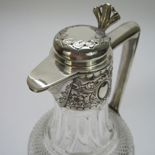 LATE VICTORIAN SILVER AND CUT GLASS CLARET JUG WITH HINGED DOMED FLORAL LID - ADDITIONAL PHOTO 1
