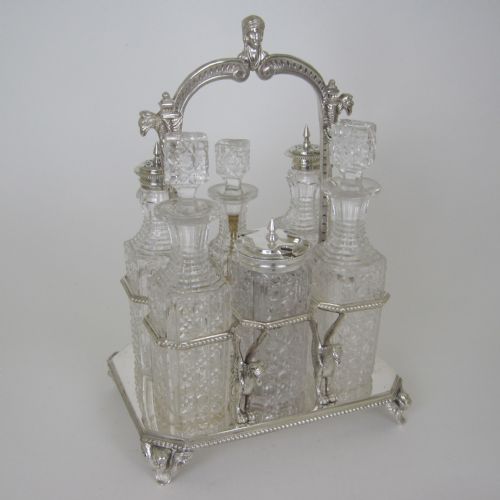 6 bottle victorian silver plated cruet set with loop cast figural handle - CATEGORY: ANTIQUE SILVER - DATED 1880