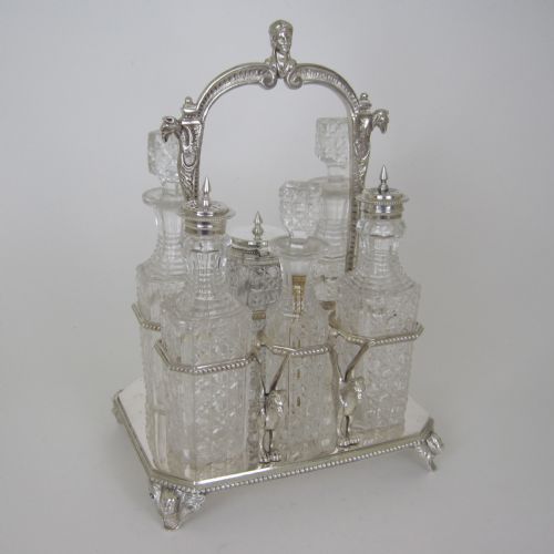 6 BOTTLE VICTORIAN SILVER PLATED CRUET SET WITH LOOP CAST FIGURAL HANDLE - ADDITIONAL PHOTO 1