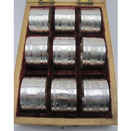 BOXED SET OF NINE EDWARDIAN SILVER NAPKIN RINGS IN INLAID WOODEN BOX - ADDITIONAL PHOTO 1
