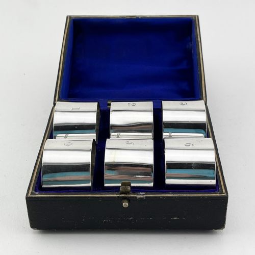 SIX PLAIN EDWARDIAN STERLING SILVER NAPKIN RINGS IN ORIGINAL SILK LINED BOX