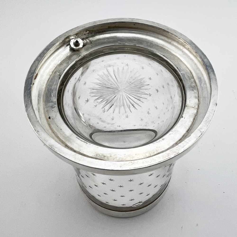 A Victorian clear glass mug featuring etched star motifs, a silver-plated rim, a stepped silver base, and a decorative scrolling handle. View IV