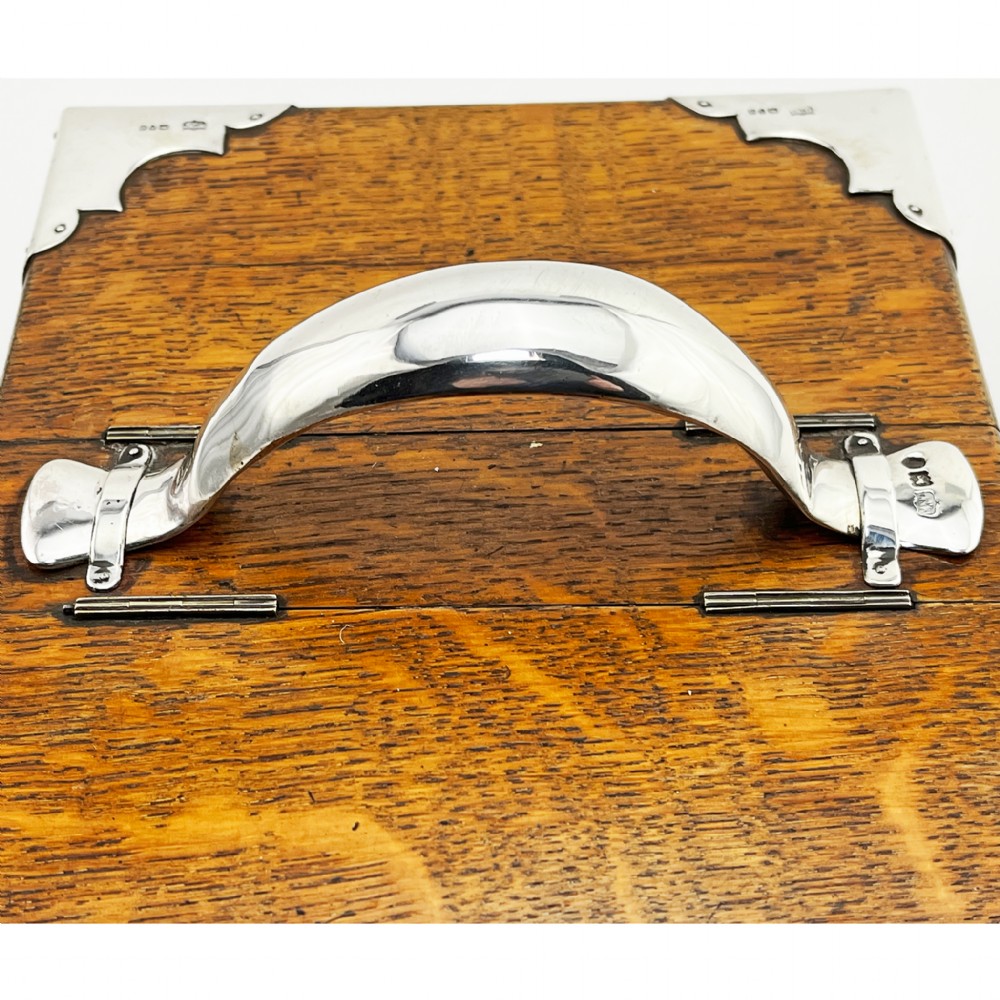 A rectangular oak wood box featuring sterling silver corner mounts and a central silver handle on the lid. View IV