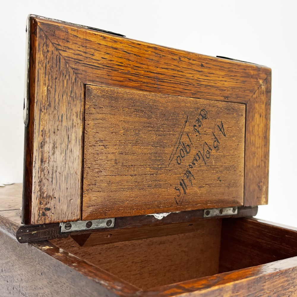 A rectangular oak wood box featuring sterling silver corner mounts and a central silver handle on the lid. View VI