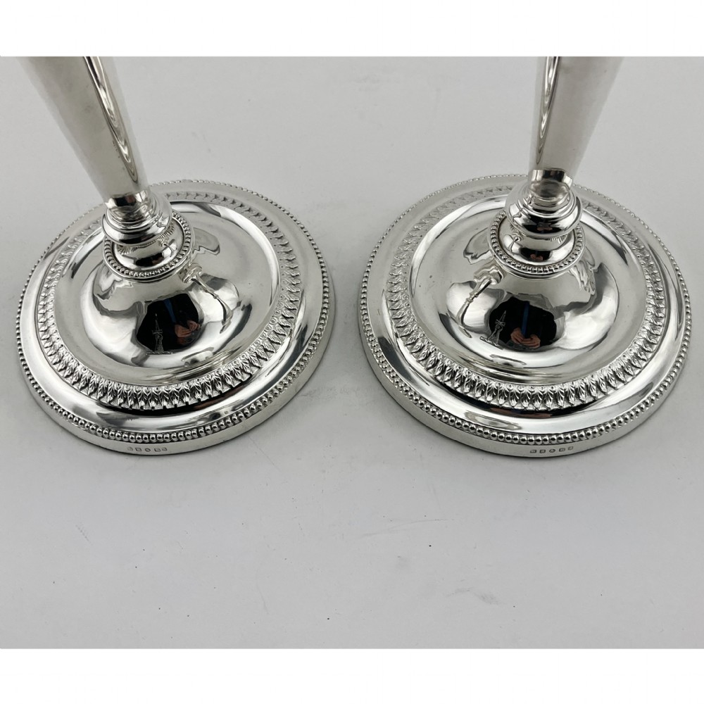 A pair of Victorian silver-plated candlesticks in Georgian Neoclassical style with drapery swags and beaded circular bases. View IV