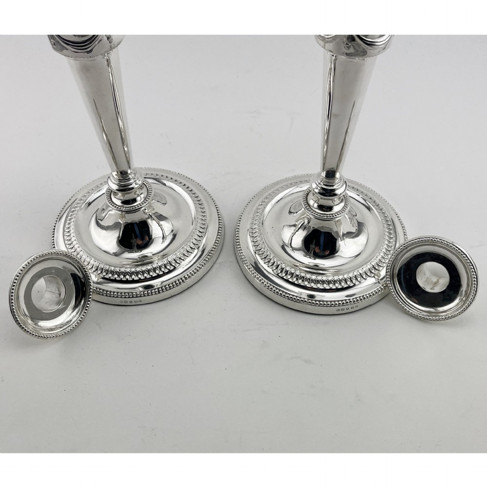 A pair of Victorian silver-plated candlesticks in Georgian Neoclassical style with drapery swags and beaded circular bases. View V