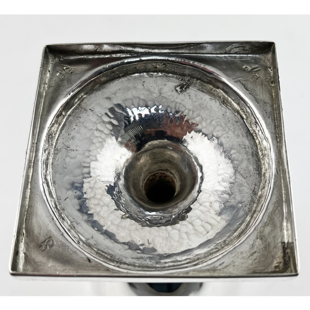 A Georgian sterling silver goblet featuring a vase-shaped bowl with engraved crest and foliate border set upon a square plinth base. View VI