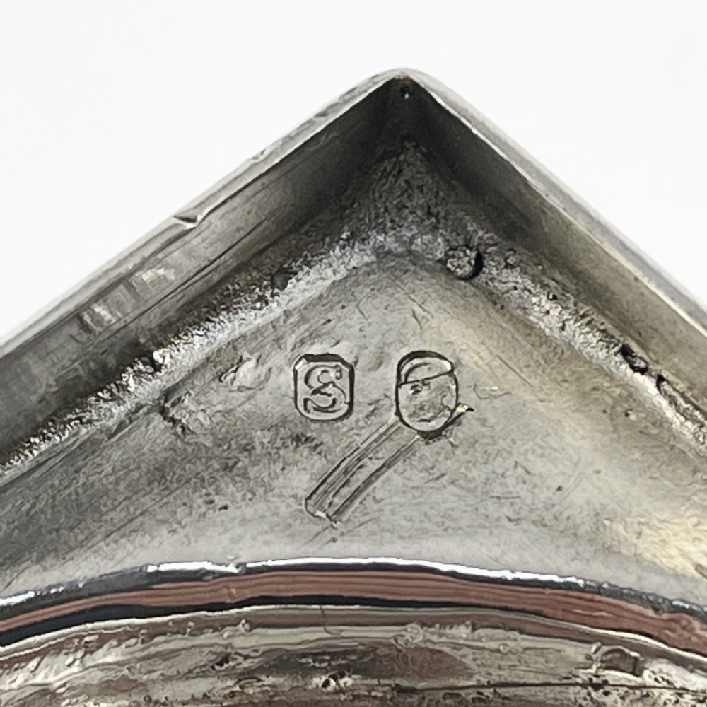 A Georgian sterling silver goblet featuring a vase-shaped bowl with engraved crest and foliate border set upon a square plinth base. View VII