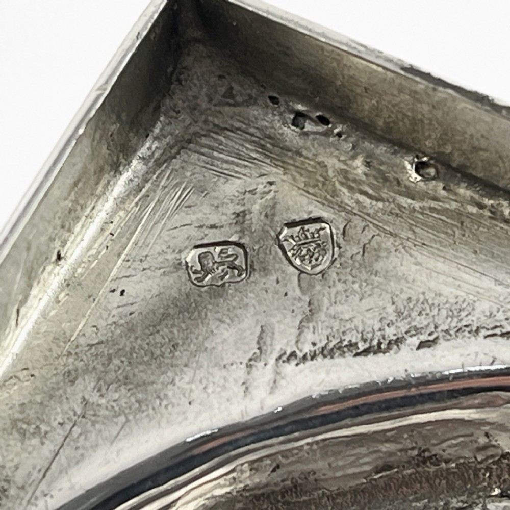 A Georgian sterling silver goblet featuring a vase-shaped bowl with engraved crest and foliate border set upon a square plinth base. View VIII