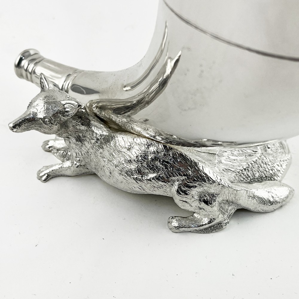 A Victorian silver-plated spoon warmer shaped like a curved horn with a sculpted animal figure at the base. View II