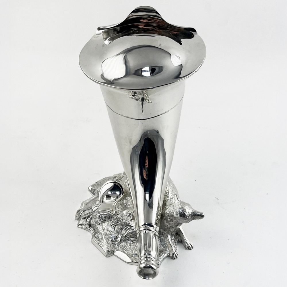 A Victorian silver-plated spoon warmer shaped like a curved horn with a sculpted animal figure at the base. View IV