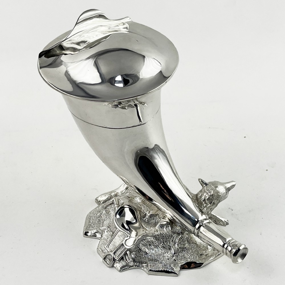 A Victorian silver-plated spoon warmer shaped like a curved horn with a sculpted animal figure at the base. View VI