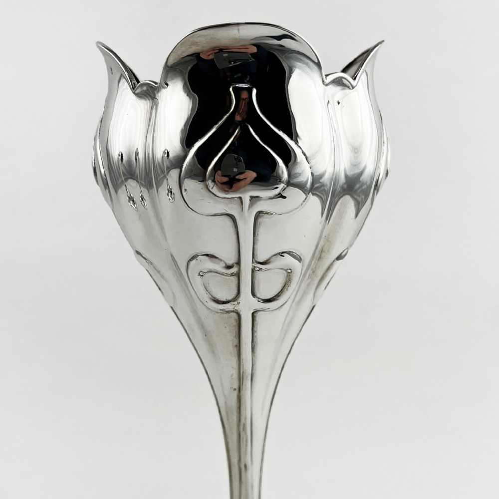 A pair of polished sterling silver Art Nouveau stem vases featuring flared scalloped rims, slender stems, and embossed floral whiplash motifs on circular bases. View II