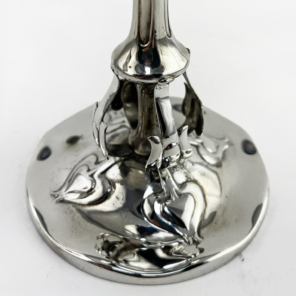 A pair of polished sterling silver Art Nouveau stem vases featuring flared scalloped rims, slender stems, and embossed floral whiplash motifs on circular bases. View IV