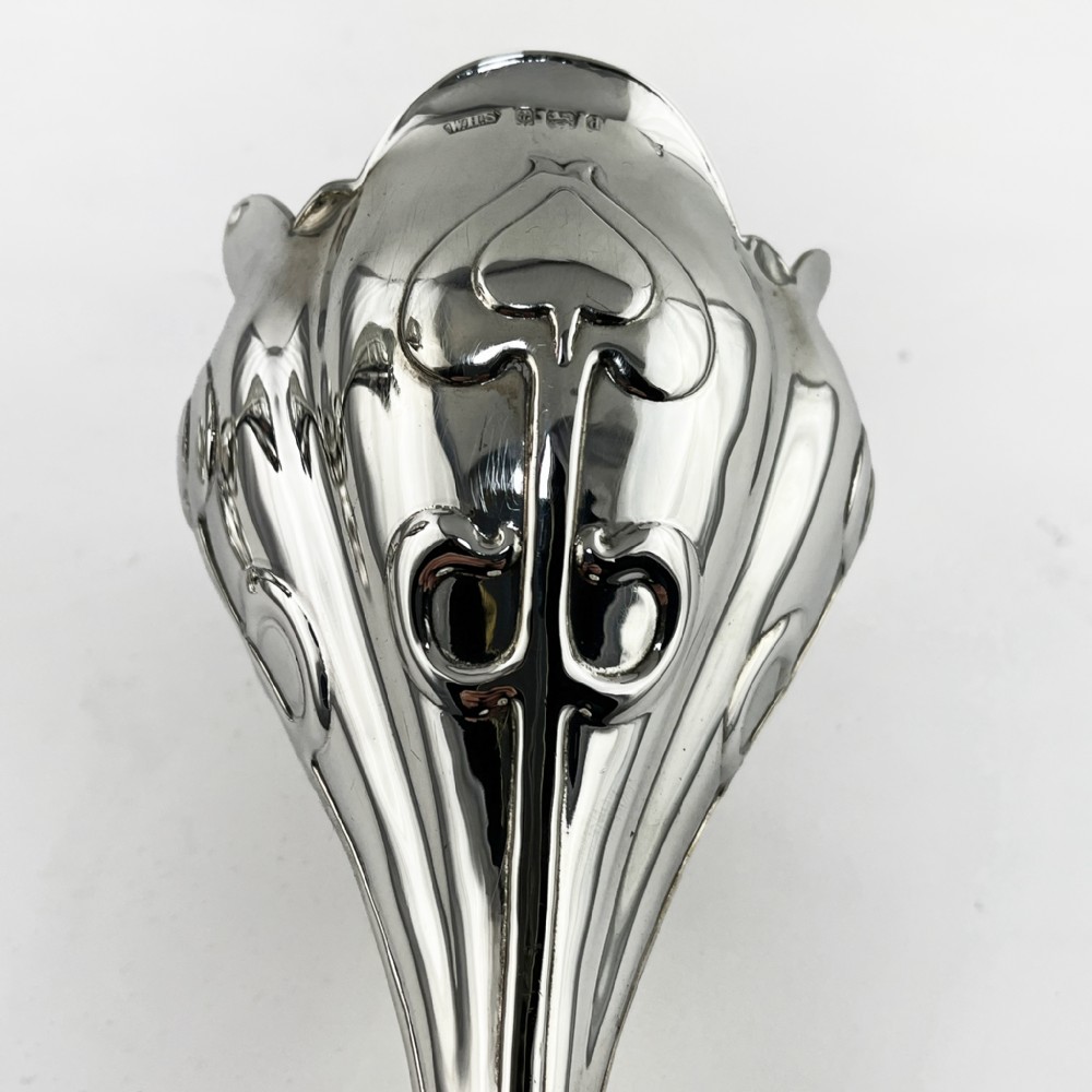 A pair of polished sterling silver Art Nouveau stem vases featuring flared scalloped rims, slender stems, and embossed floral whiplash motifs on circular bases. View V
