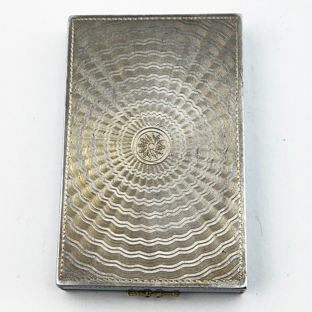 A rectangular sterling silver card case featuring bright blue guilloche enamel framed by white scroll enamel and silver gilt borders. View VII