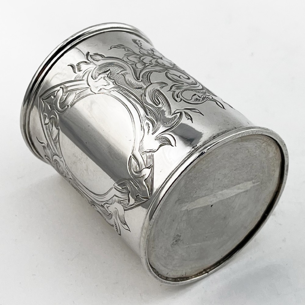 A Victorian sterling silver christening mug featuring floral engraving and a silver-gilt interior. View VI