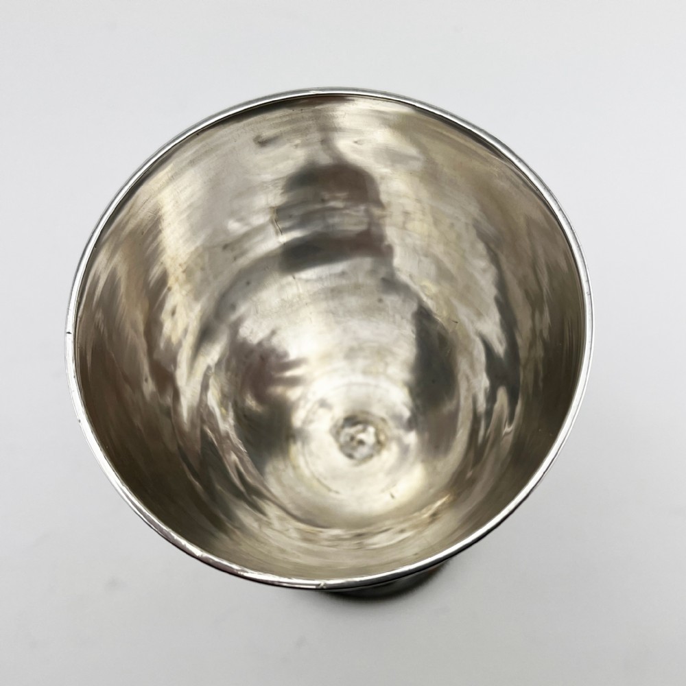 A Victorian sterling silver goblet featuring detailed floral foliage engraving around the bowl, a central knopped stem, and an engraved circular base. View IV