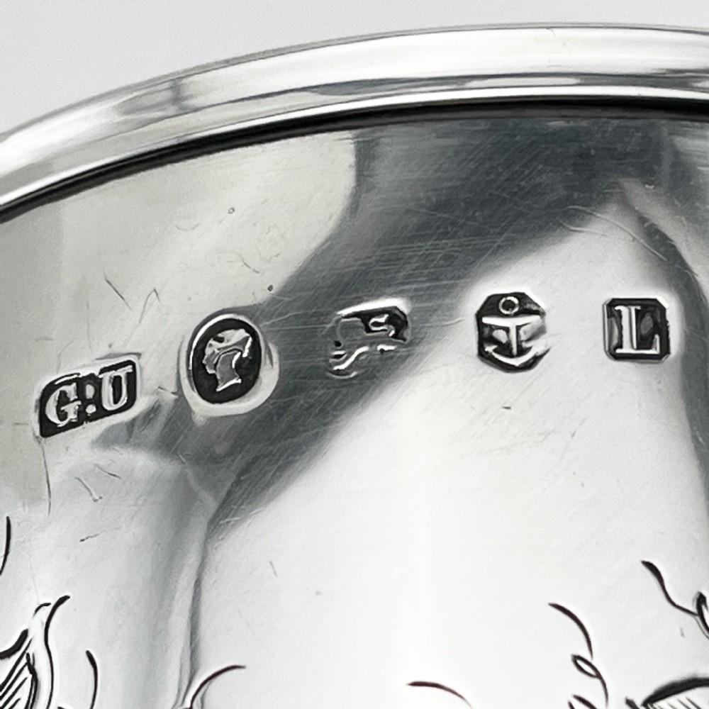 A Victorian sterling silver goblet featuring detailed floral foliage engraving around the bowl, a central knopped stem, and an engraved circular base. View VI