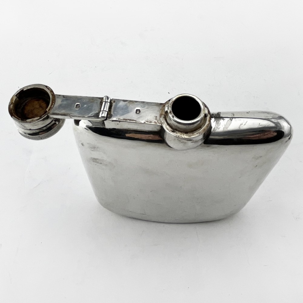 A plain, curved sterling silver hip flask featuring a hinged cap and polished metallic finish. View III