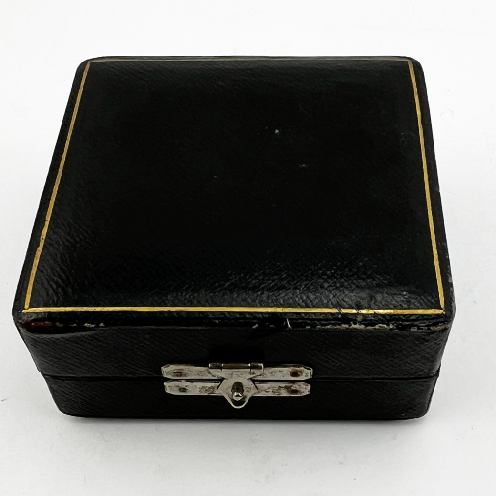 A set of six silver-plated napkin rings numbered one to six with reeded borders, stored in an open black case lined with blue silk and velvet. View VI