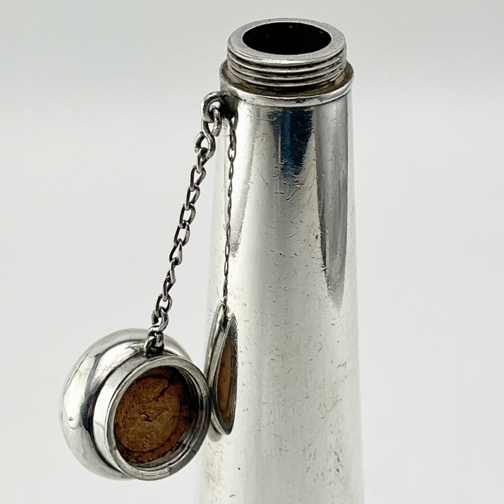 A conical Victorian sterling silver hunting saddle flask featuring an engraved coat of arms and a rounded silver cap. View III
