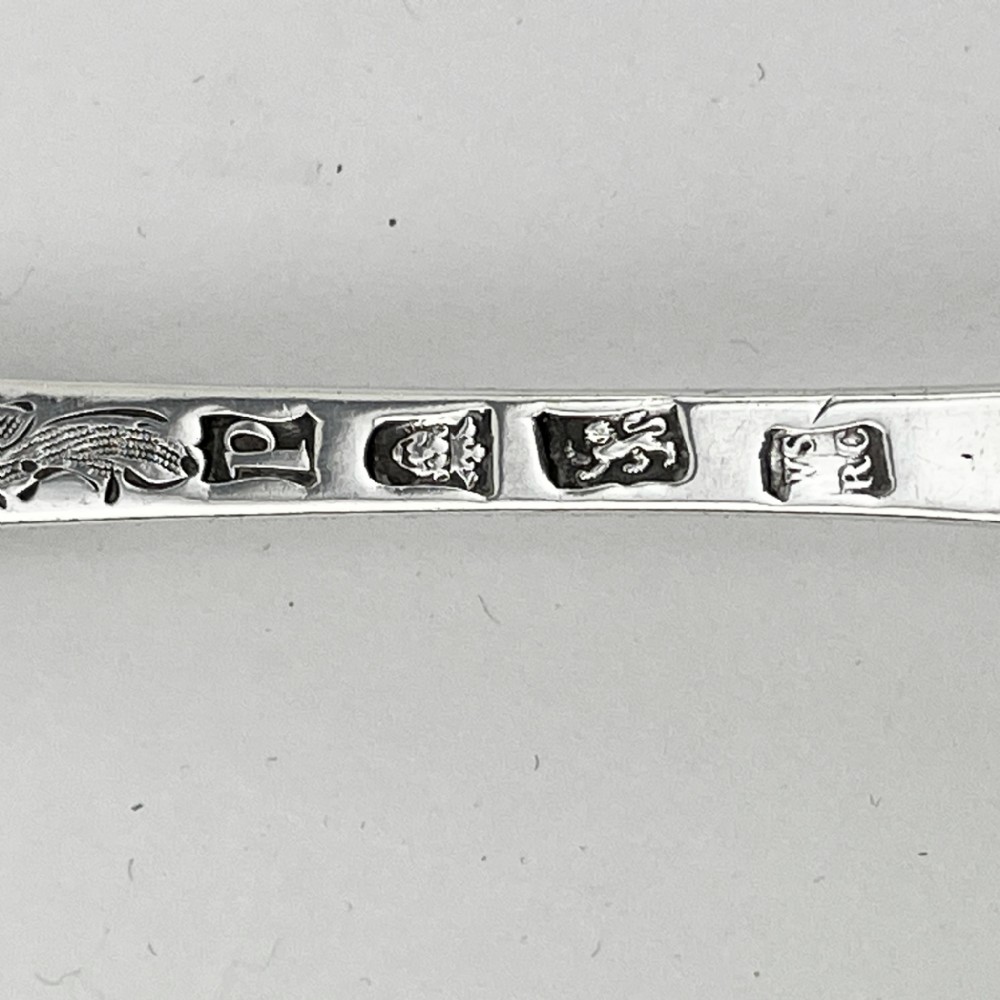 A pair of George III sterling silver berry spoons with fruit embossed bowls and chased handles, presented in a black velvet and purple silk lined case. View VI