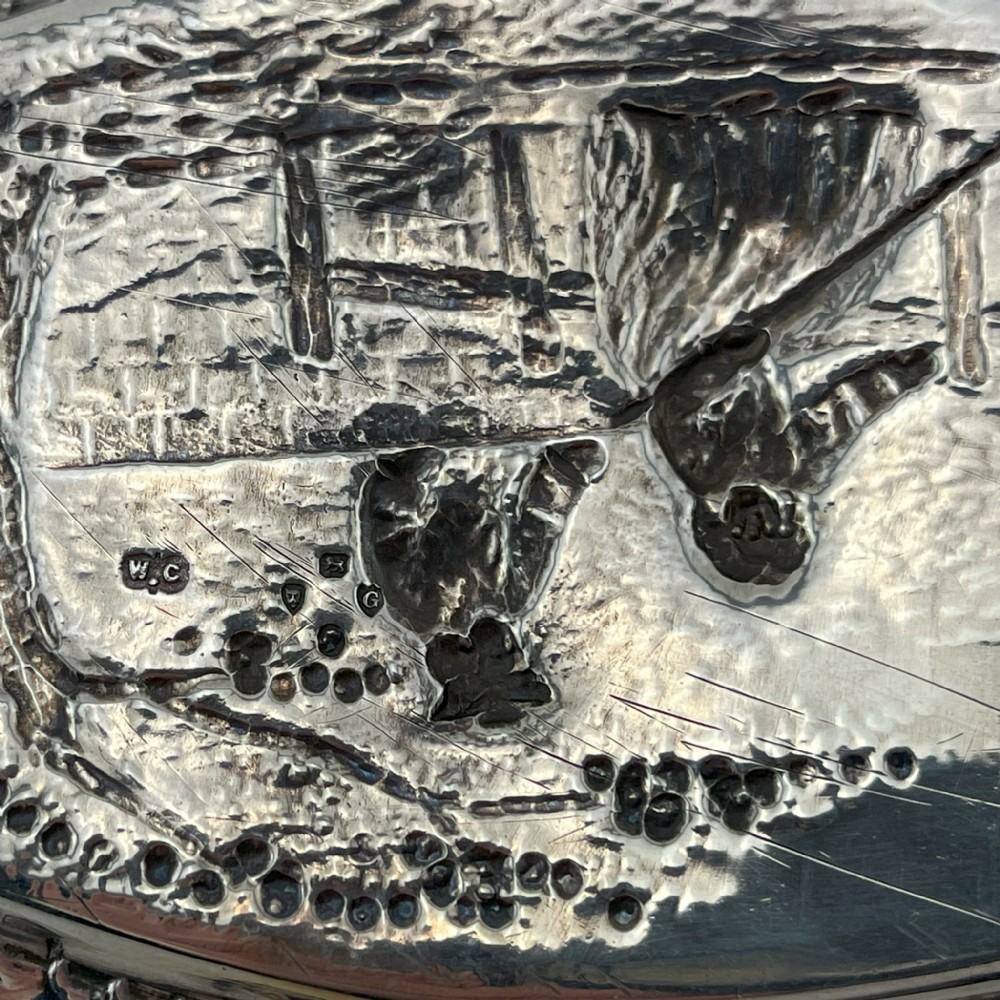 A pair of Victorian sterling silver dishes featuring relief-embossed pastoral scenes with ornate scrolled borders. View IV
