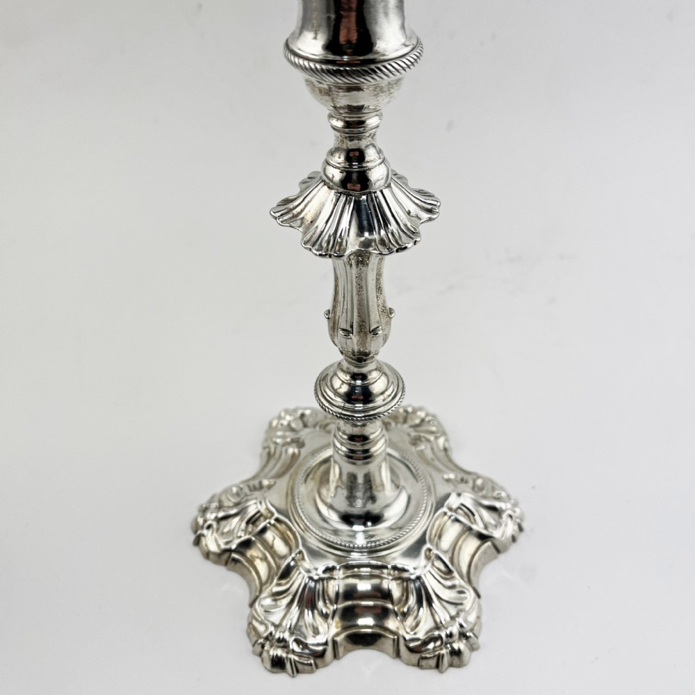 A pair of cast sterling silver George II candlesticks with shell-detailed bases and knopped stems. View III