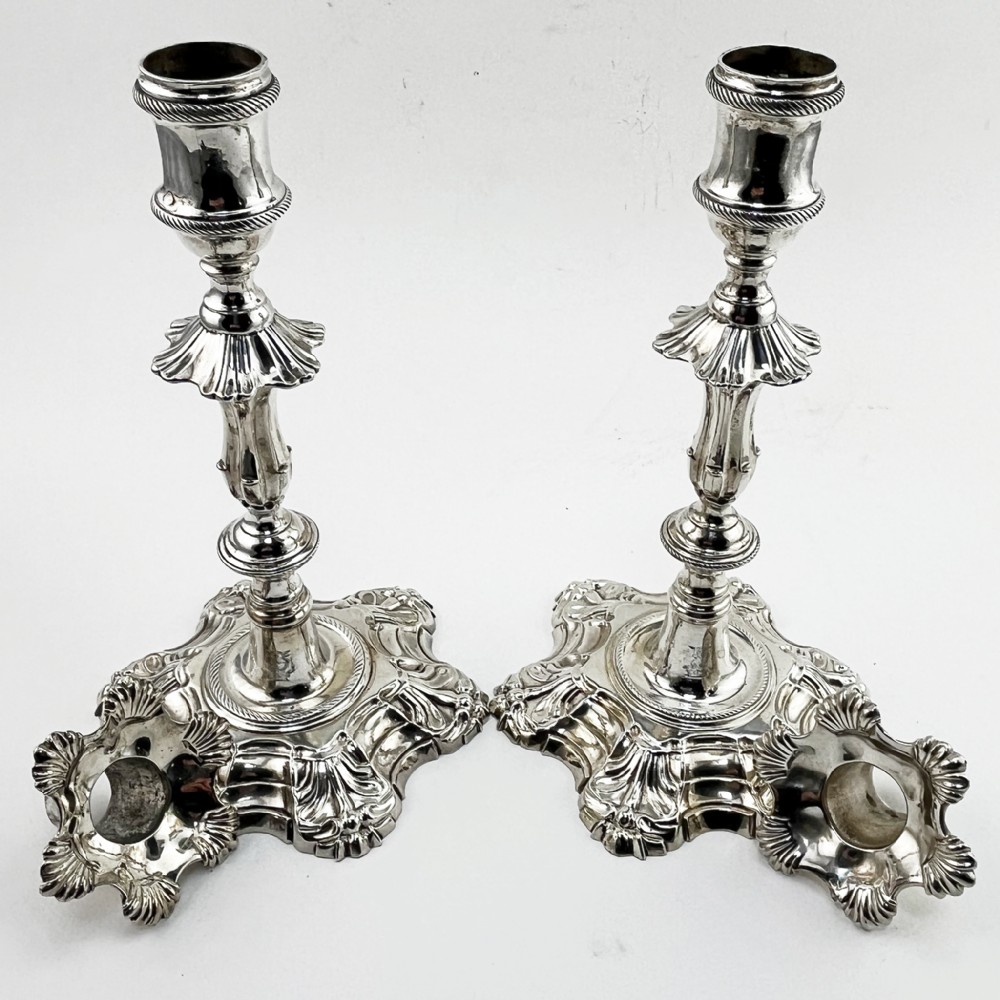 A pair of cast sterling silver George II candlesticks with shell-detailed bases and knopped stems. View VI
