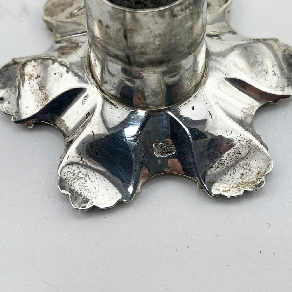 A pair of cast sterling silver George II candlesticks with shell-detailed bases and knopped stems. View VII