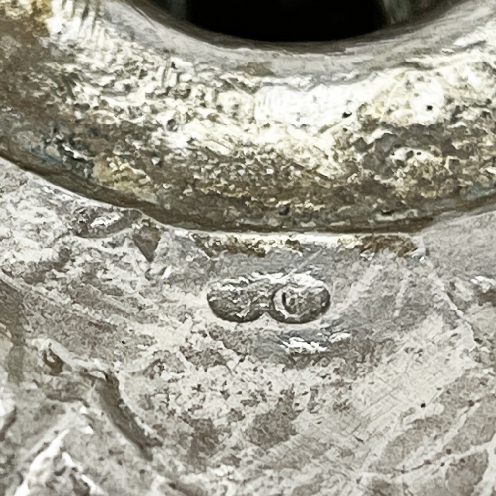 A pair of cast sterling silver George II candlesticks with shell-detailed bases and knopped stems. View XI