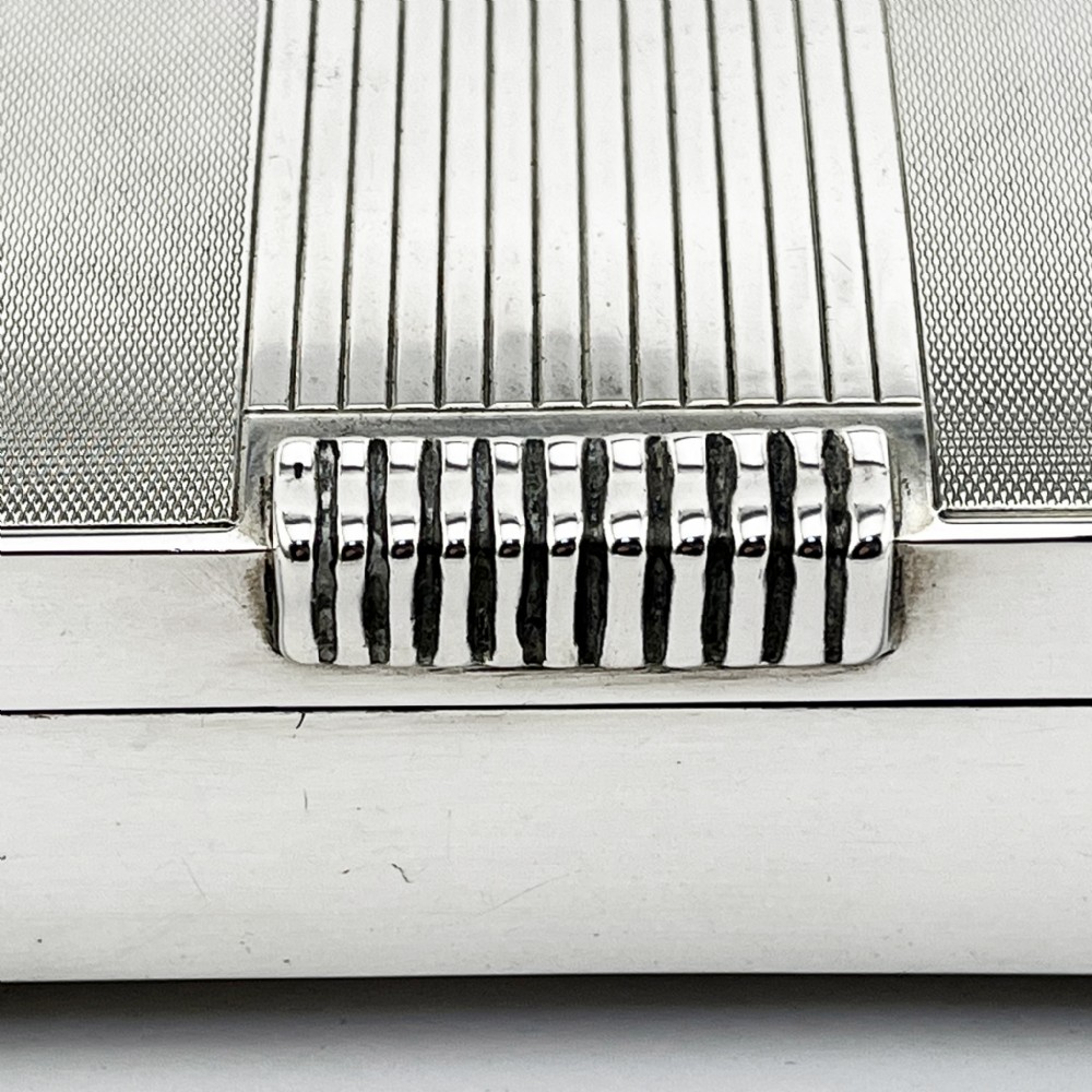 A rectangular sterling silver Art Deco box featuring engine-turned panels, a central vertical ribbed band, and ribbed corner feet. View VII