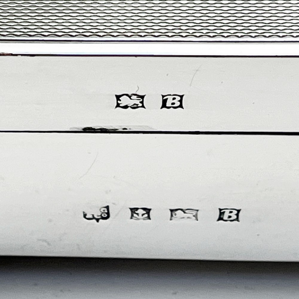 A rectangular sterling silver Art Deco box featuring engine-turned panels, a central vertical ribbed band, and ribbed corner feet. View VIII