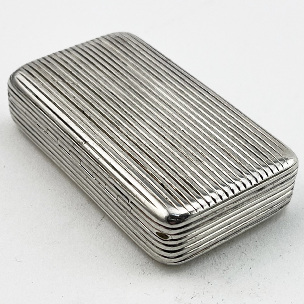 A small rectangular Georgian sterling silver snuff box with a hinged lid and horizontal reeded stripe decoration. View III