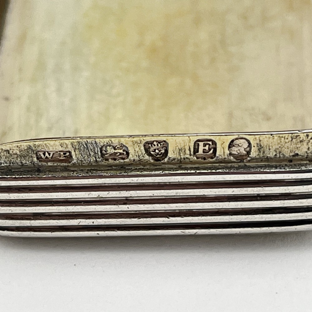 A small rectangular Georgian sterling silver snuff box with a hinged lid and horizontal reeded stripe decoration. View IV