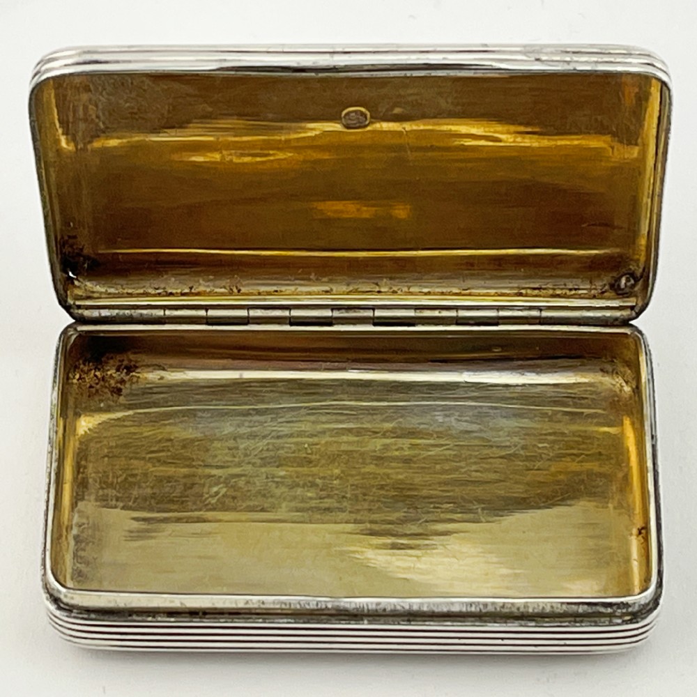A small rectangular Georgian sterling silver snuff box with a hinged lid and horizontal reeded stripe decoration. View V