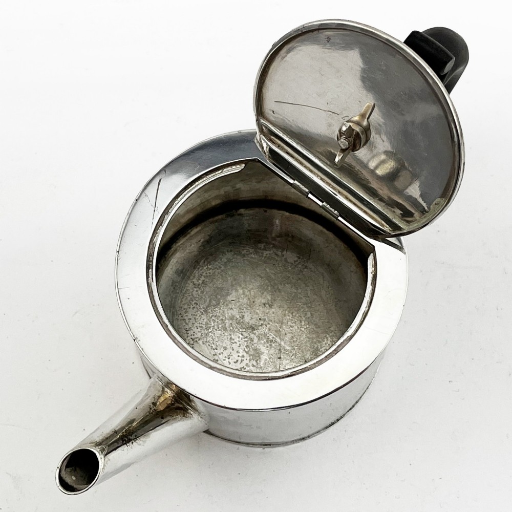 A Georgian sterling silver bachelor teapot featuring a cylindrical drum body, straight spout, and dark wooden handle and finial. View VII