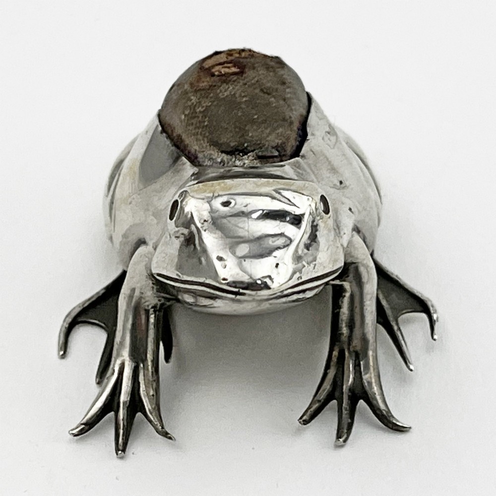 An Edwardian sterling silver pin cushion cast in the realistic shape of a frog with a dark fabric cushion inset on its back. View III
