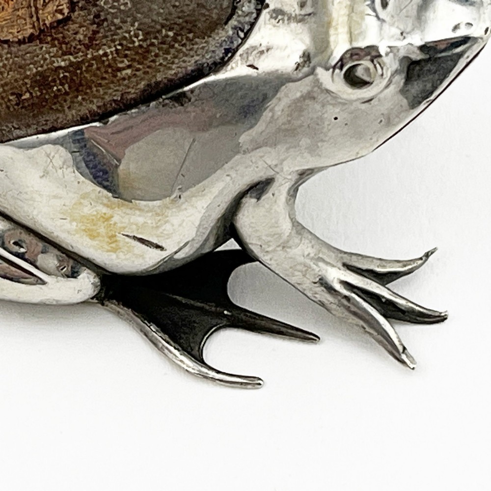 An Edwardian sterling silver pin cushion cast in the realistic shape of a frog with a dark fabric cushion inset on its back. View V