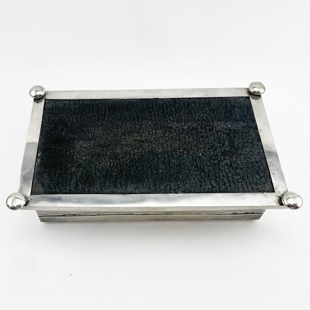 A rectangular sterling silver trinket box featuring engine-turned engraving, a beaded border, and a central engraved cartouche with initials. View VII