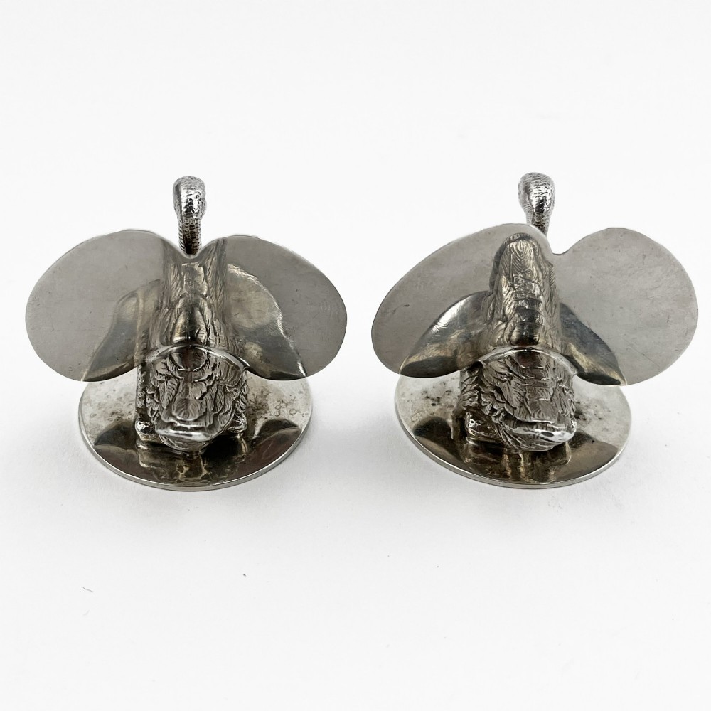 A pair of Edwardian sterling silver menu holders shaped as detailed swans resting on circular bases with central card slots. View III