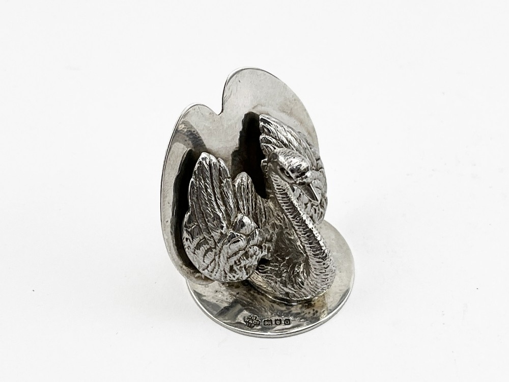 A pair of Edwardian sterling silver menu holders shaped as detailed swans resting on circular bases with central card slots. View IV